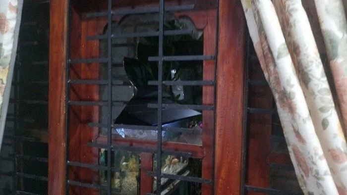 A broken pane of glass in the the door of Pastor Wilson's house.