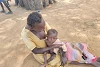 A mother in South Sudan holds her malnourished baby. csi