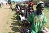 People selected to receive food aid hold up their cards during a food distribution action in South Sudan. csi